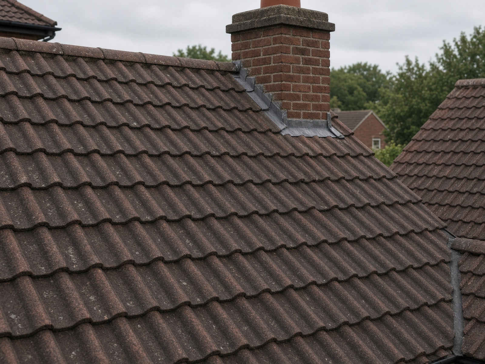 Illustrative photograph of a UK clay-tiled roof — not a McLaren Projects completed job